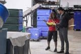 Two people discussing career paths in an industrial warehouse setting.