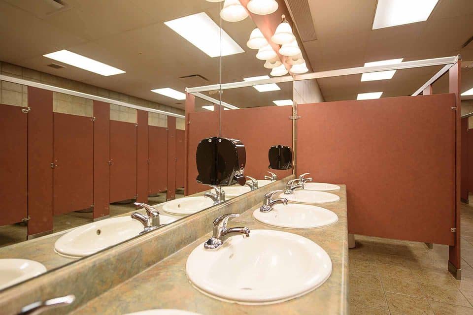 Public restroom with multiple sinks and stalls.