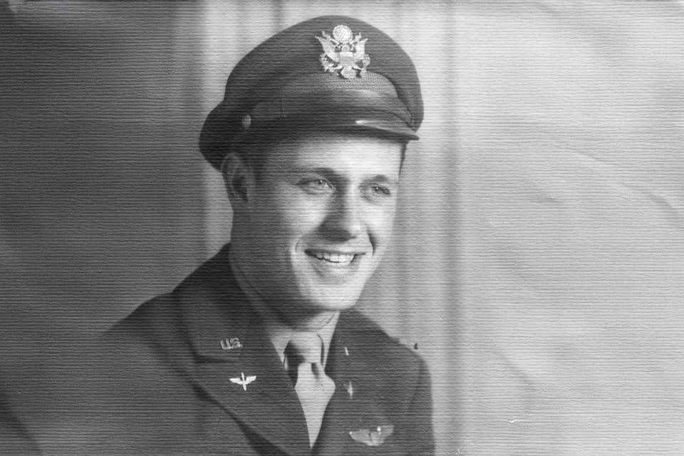 Black and white portrait of a man in a U.S. military uniform and cap.